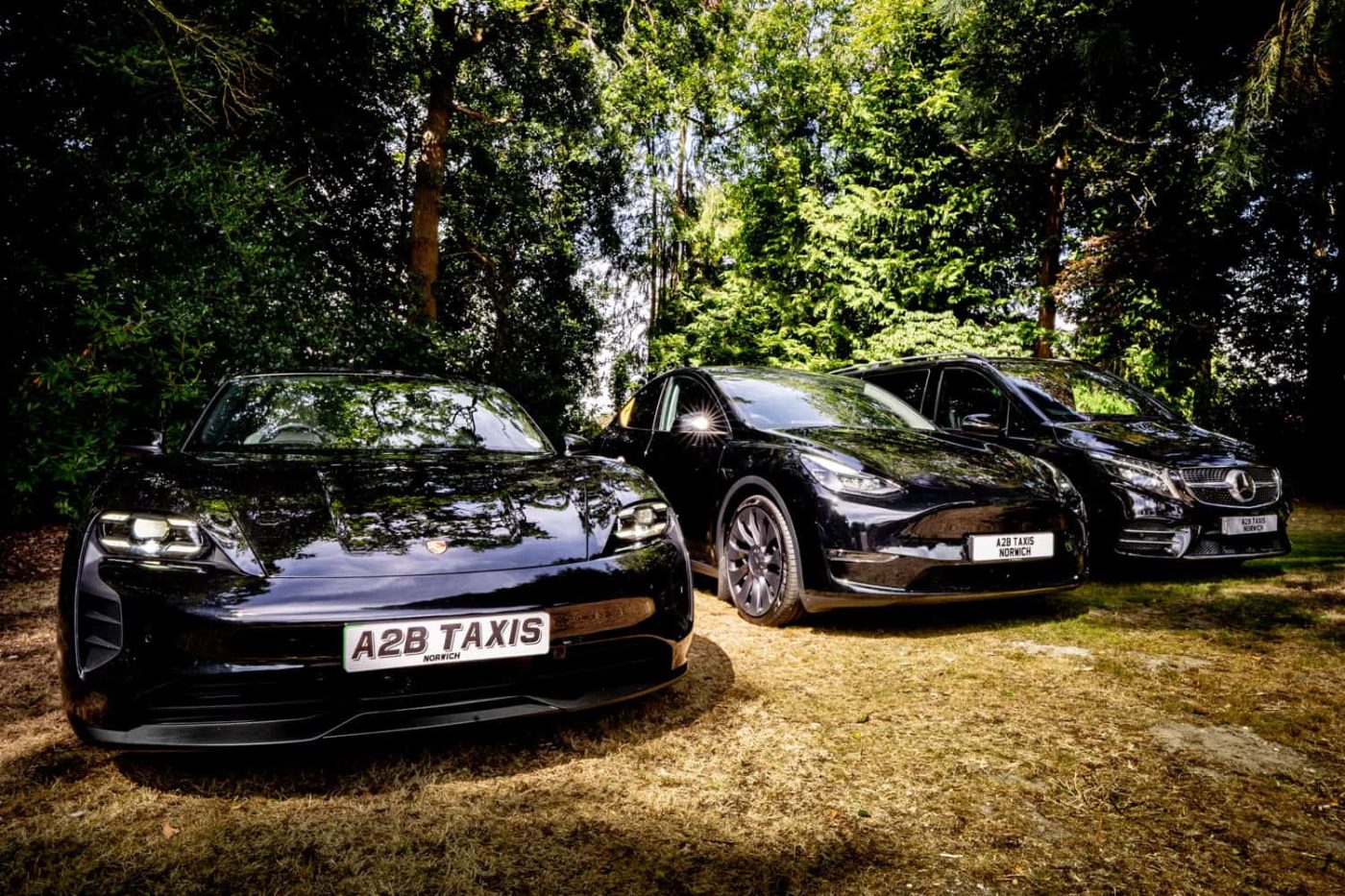A2B executive fleet line-up featuring the Porsche Taycan, Tesla Model Y and Mercedes V-Class